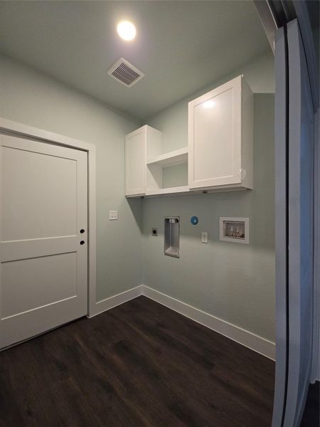 Laundry room with washer hookup, dark wood-style flooring, hookup for an electric dryer, cabinet space, and hookup for a gas dryer