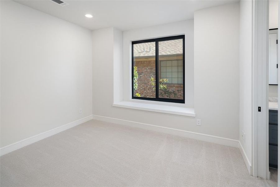 Empty room with light colored carpet