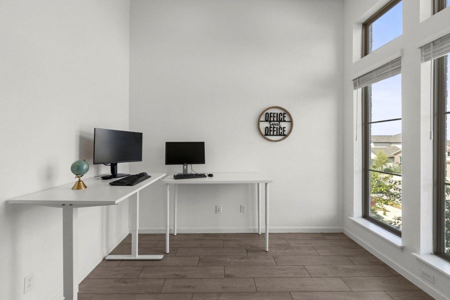 Soaring ceilings and large windows create an airy atmosphere in this quiet workspace.