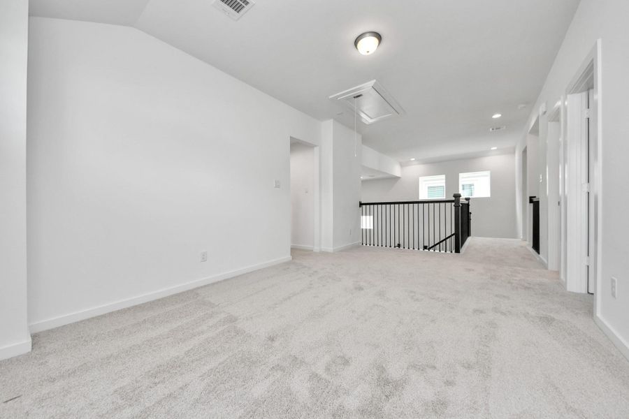 Come upstairs and enjoy a day of leisure in this fabulous game room! This is the perfect hangout spot or adult game room! Features plush carpet, high ceilings, custom paint and windows for plenty of natural light. Sample photo of completed home with similar floor plan. Actual colors and selections may vary. Come upstairs and enjoy a day of leisure in this fabulous game room! This is the perfect hangout spot or adult game room! Features plush carpet, high ceilings, custom paint and windows for plenty of natural light. Sample photo of completed home with similar floor plan. Actual colors and selections may vary.