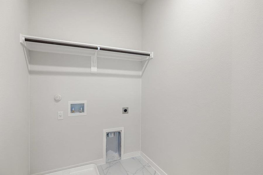 Washroom featuring hookup for an electric dryer, hookup for a washing machine, marble finish flooring, and gas dryer hookup