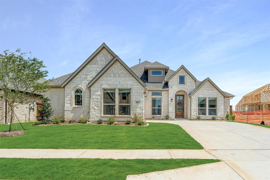 Front exterior of a new home in Wildflower Ranch 60-65, Justin, TX, highlighting curb appeal (Image 2). Front exterior of a new home in Wildflower Ranch 60-65, Justin, TX, highlighting curb appeal (Image 2).
