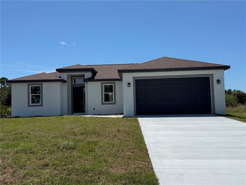 Front exterior of a new home in , Port Charlotte, FL, highlighting curb appeal (Image 1). Front exterior of a new home in , Port Charlotte, FL, highlighting curb appeal (Image 1).