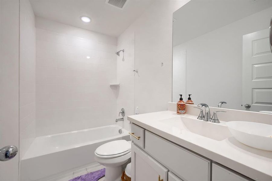 Full bathroom with vanity, toilet, and washtub / shower combination