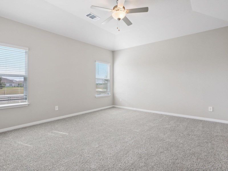 Unfurnished room with ceiling fan, carpet flooring, and baseboards Unfurnished room with ceiling fan, carpet flooring, and baseboards