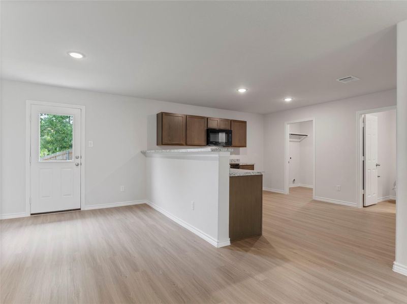 Bright dining area seamlessly connected to an open kitchen. Bright dining area seamlessly connected to an open kitchen.