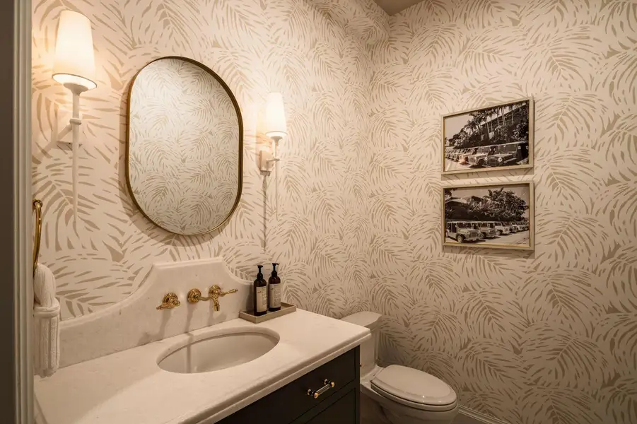 26 - Powder room with cream palm wallpap
