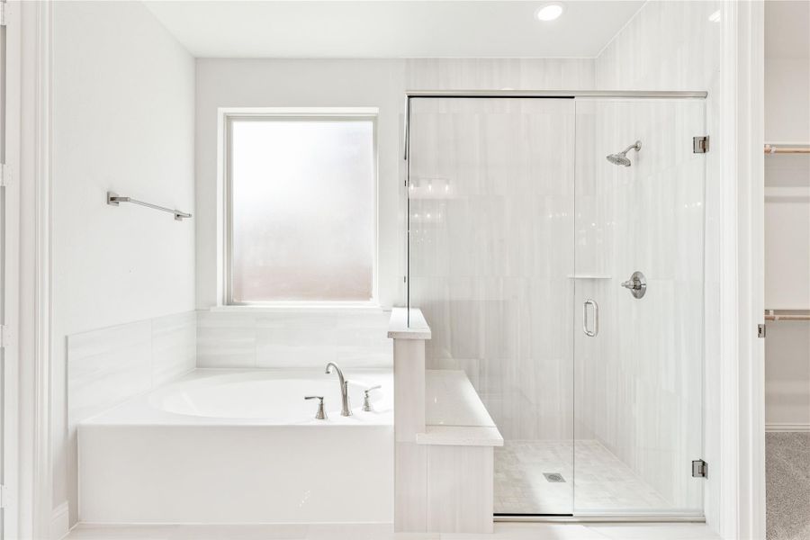 White master bathroom with soaking tub, glass-enclosed shower, and chrome fixtures White master bathroom with soaking tub, glass-enclosed shower, and chrome fixtures