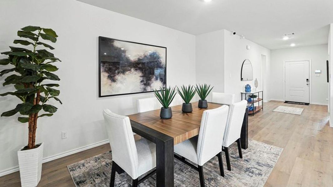 Dining space with light wood-type flooring and recessed lighting Dining space with light wood-type flooring and recessed lighting