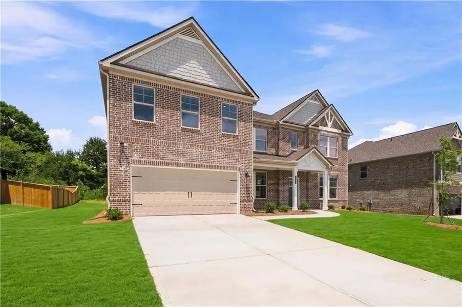 Front exterior of a new home in Adagio, Dacula, GA, highlighting curb appeal (Image 16).