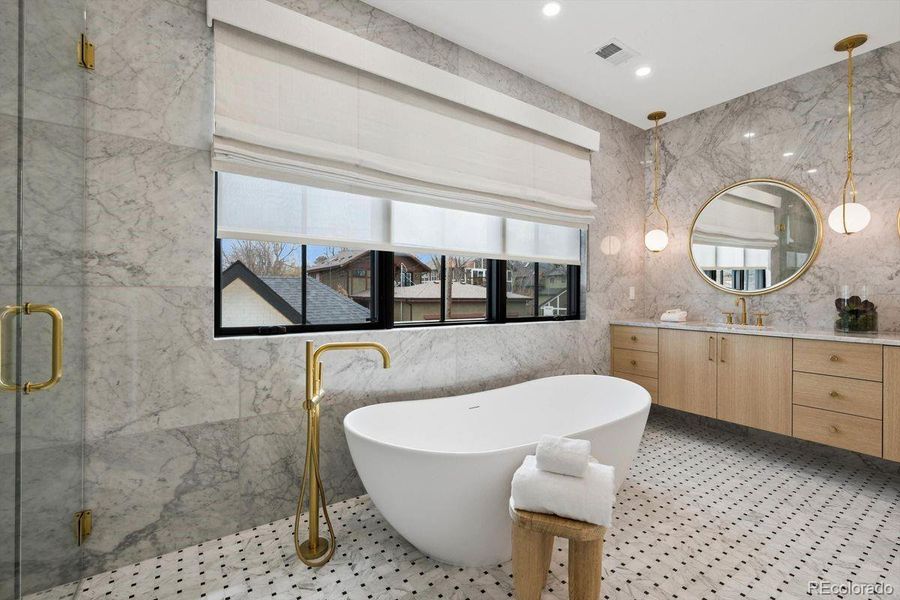 Spa like primary bath with motorized shades!