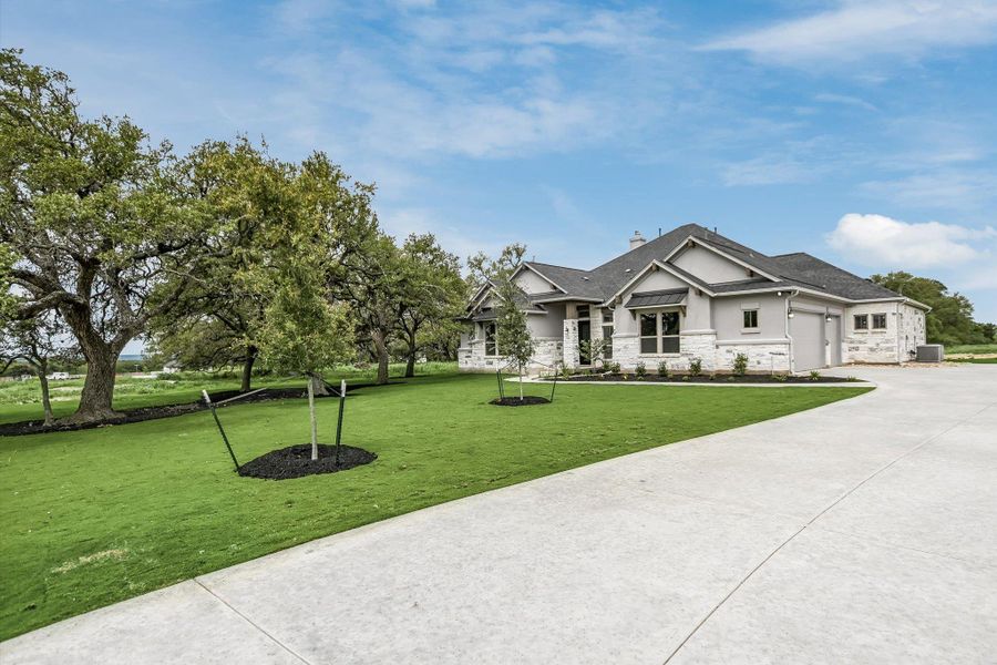 Front exterior of a new home in Leander Estates, Leander, TX, highlighting curb appeal (Image 21).