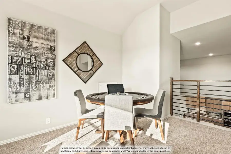 Loft game room with round poker table, gray chairs, vaulted ceiling, and metal railing overlooking lower level