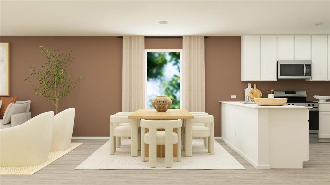 Kitchen featuring appliances with stainless steel finishes, white cabinets, light countertops, and baseboards