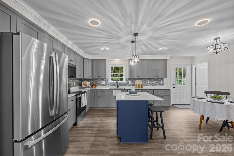 Large kitchen with recessed lighting and island.
