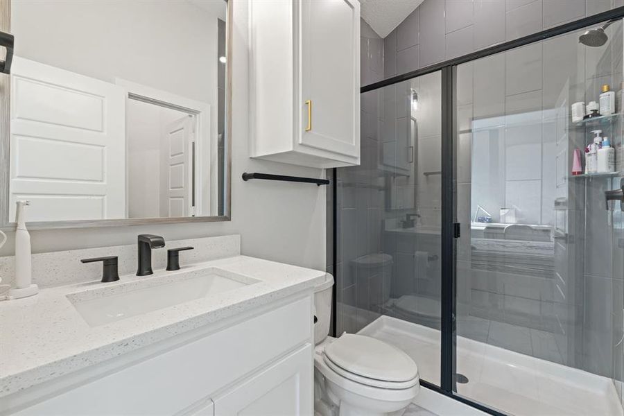 Full bathroom with vanity and a stall shower