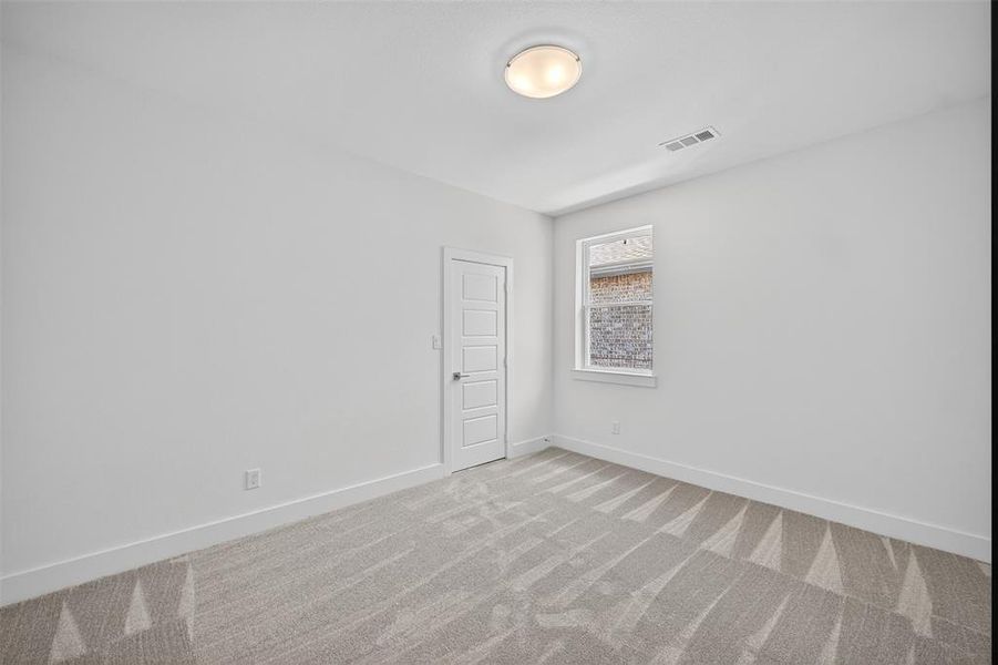Unfurnished room with baseboards and carpet floors