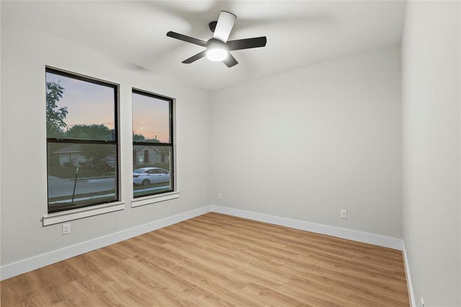 Unfurnished room with ceiling fan and light wood-type flooring