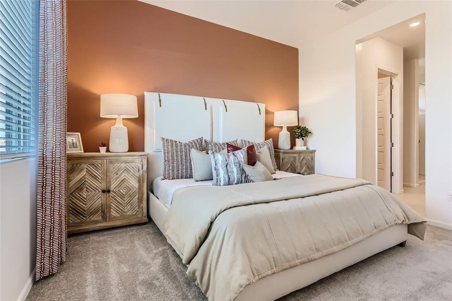 Bedroom featuring carpet and baseboards