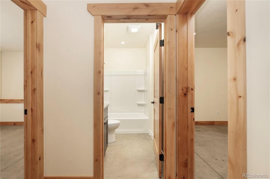 Hallway between basement bedrooms and full bathroom