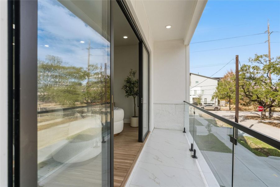 Private balcony with glass railing, perfect for outdoor seating or morning coffee.Seamless access from the living area enhances indoor-outdoor living.