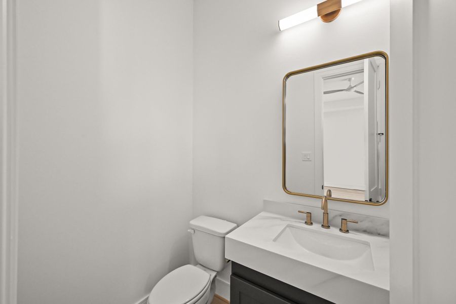 Serving both the game room and media room is a convenient powder bath!