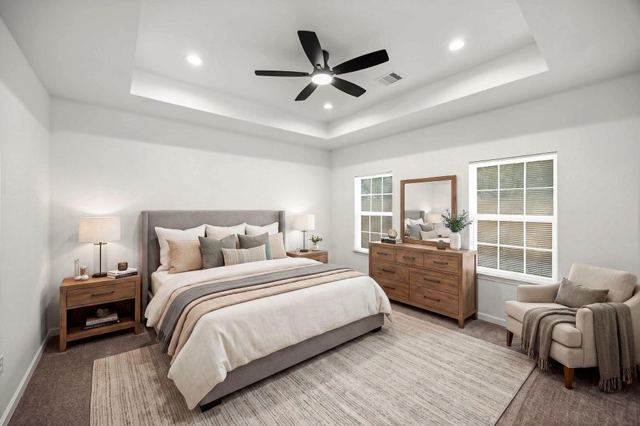 Primary bedroom with coffered ceiling, recessed lighting, ceiling fan, and large windows providing abundant natural light