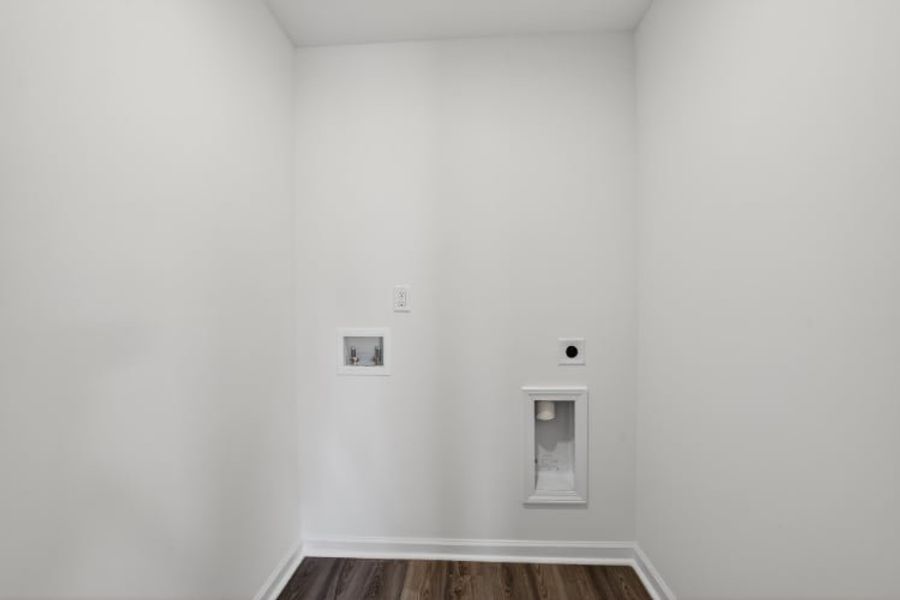 A white wall with a light switch.