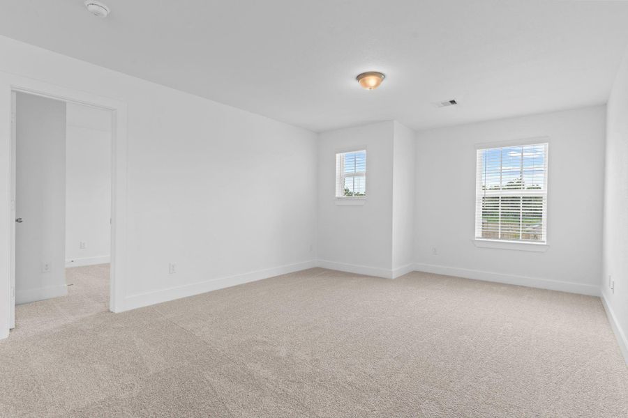 The upstairs game room offers a spacious and versatile retreat, featuring double windows, soft carpeting, and open views to the downstairs—ideal for movie nights, a play area, or a secondary lounge. **Image Representative of Plan Only and May Vary as Built**. The upstairs game room offers a spacious and versatile retreat, featuring double windows, soft carpeting, and open views to the downstairs—ideal for movie nights, a play area, or a secondary lounge. **Image Representative of Plan Only and May Vary as Built**.