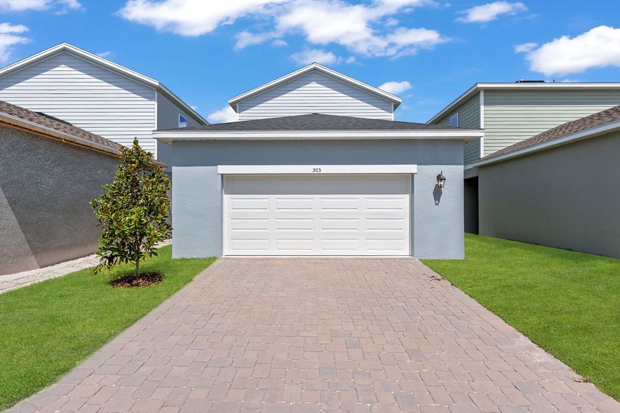 Front exterior of a new home in Brack Ranch, St. Cloud, FL, highlighting curb appeal (Image 29). Front exterior of a new home in Brack Ranch, St. Cloud, FL, highlighting curb appeal (Image 29).