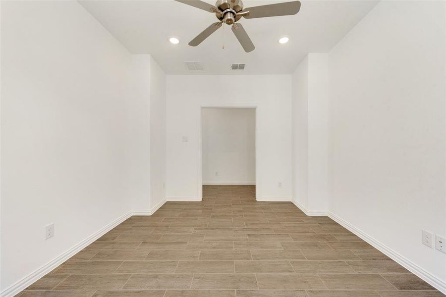 Empty room featuring light wood-type flooring and ceiling fan