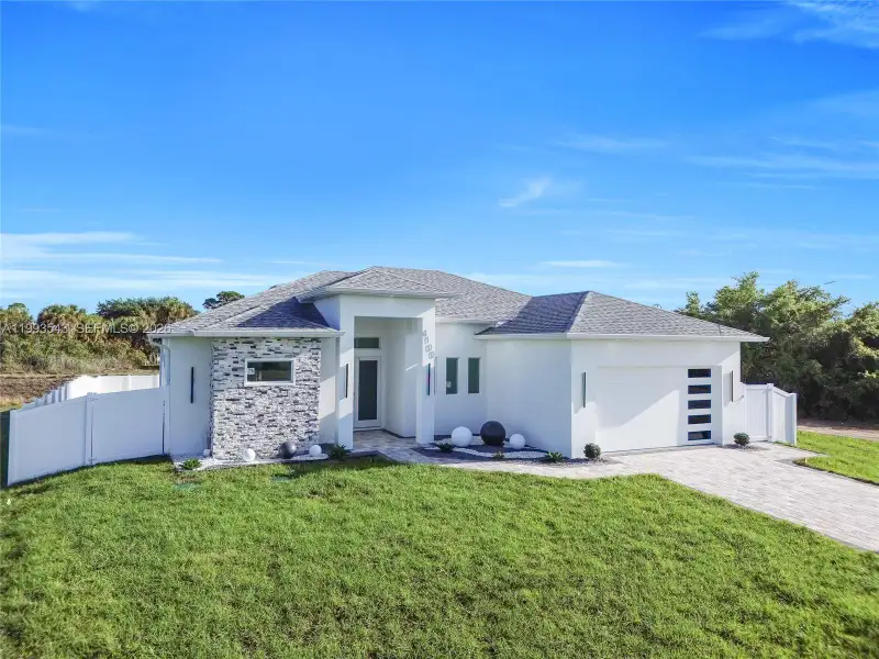 Front exterior of a new home in , Lehigh Acres, FL, highlighting curb appeal (Image 24).