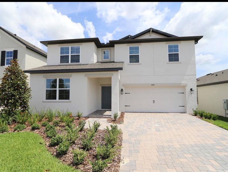 Front exterior of a new home in Epperson, Wesley Chapel, FL, highlighting curb appeal (Image 1). Front exterior of a new home in Epperson, Wesley Chapel, FL, highlighting curb appeal (Image 1).
