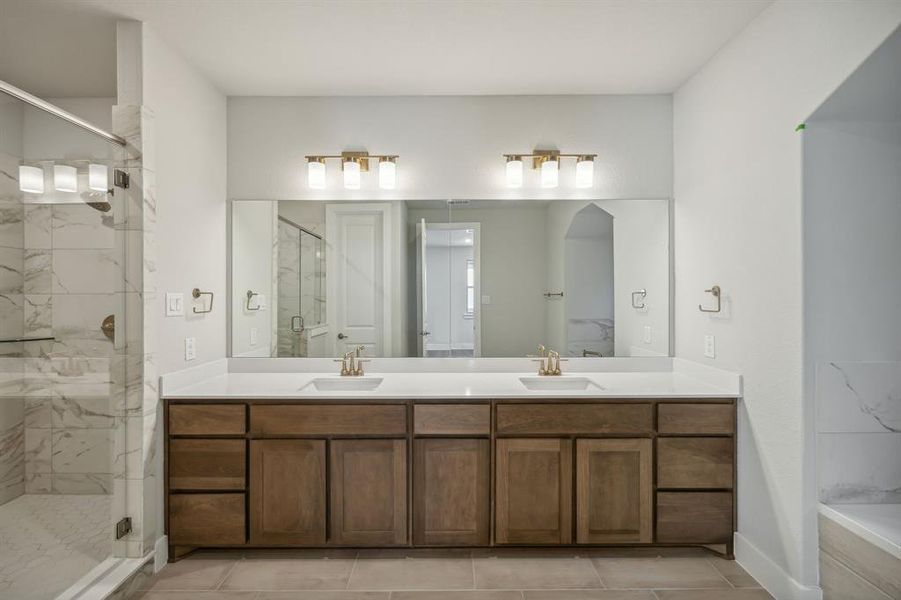 Bathroom with tile patterned floors, walk in shower, and vanity