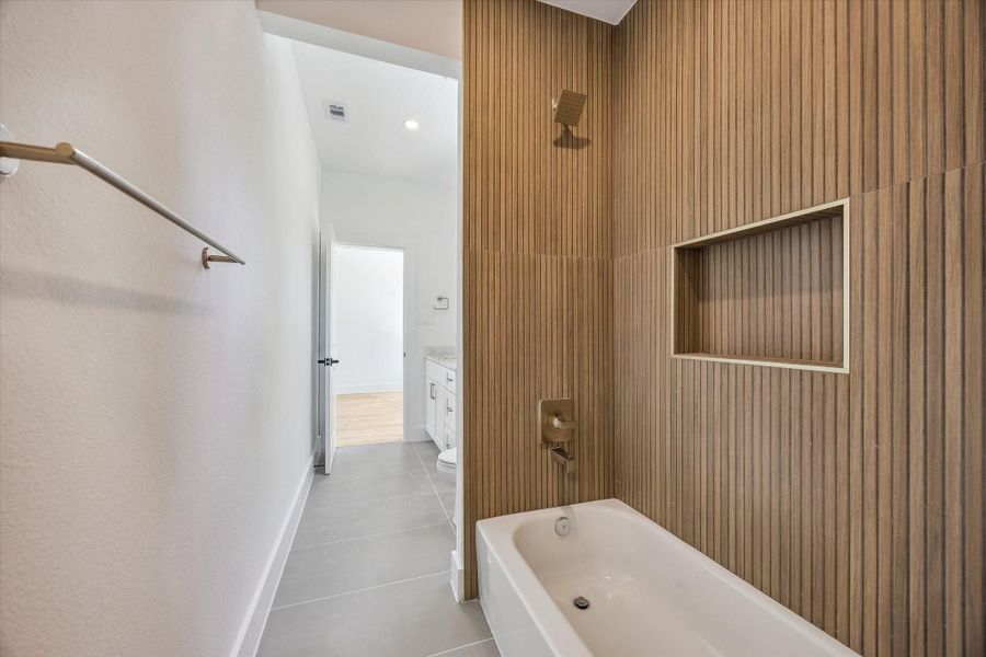 First floor ensuite bathroom with a walk-in closet.