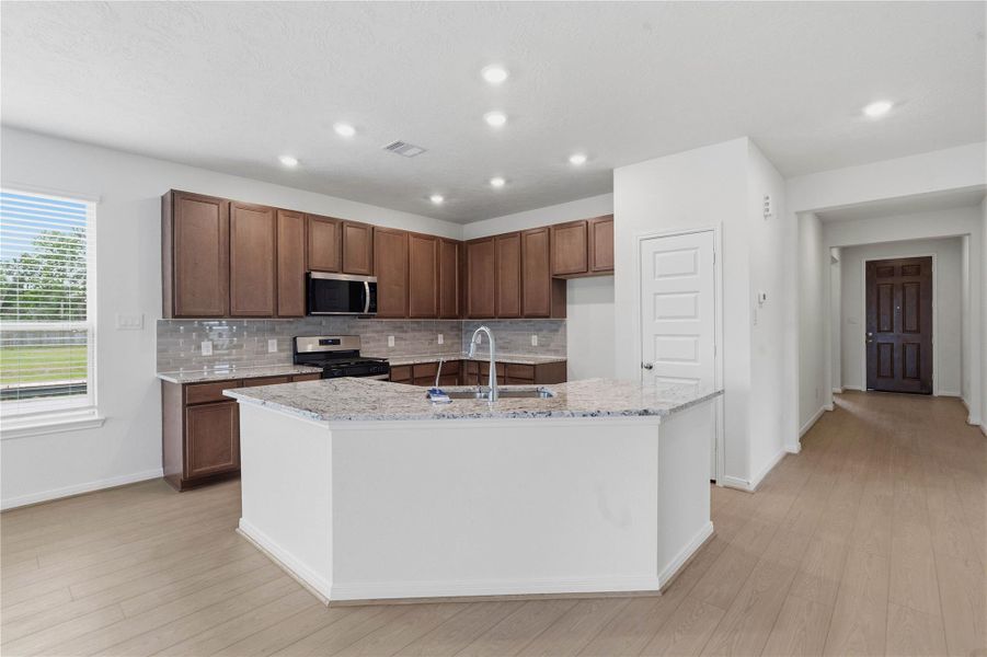 This spacious kitchen has it all—ample storage, generous counter space, and a layout that truly makes it the heart of the home. This spacious kitchen has it all—ample storage, generous counter space, and a layout that truly makes it the heart of the home.