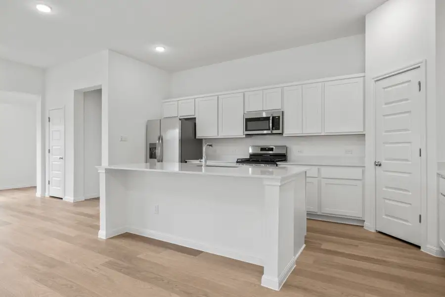 Kitchen in the Quartz home plan by Trophy Signature Homes – REPRESENTATIVE PHOTO