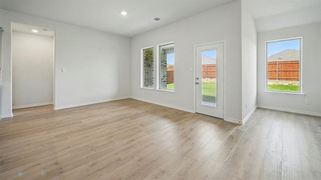 Empty room featuring light wood finished floors and recessed lighting
