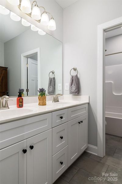 Beautiful full bath in the hallway with dual vanities!