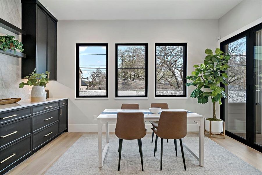 Breakfast room with built in quartzite buffet and stackable doors to screen deck
