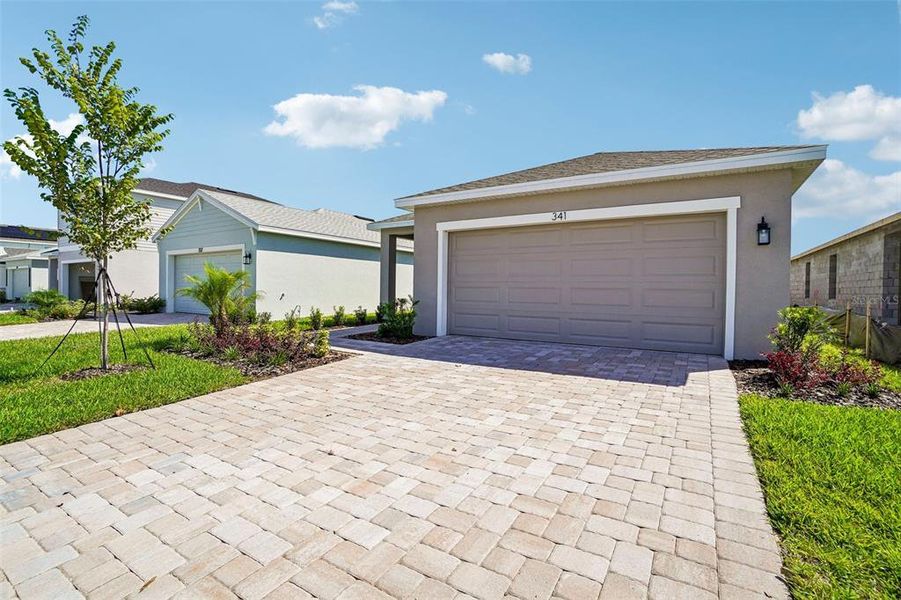 Front exterior of a new home in Willowbrook North, Winter Haven, FL, highlighting curb appeal (Image 2). Front exterior of a new home in Willowbrook North, Winter Haven, FL, highlighting curb appeal (Image 2).