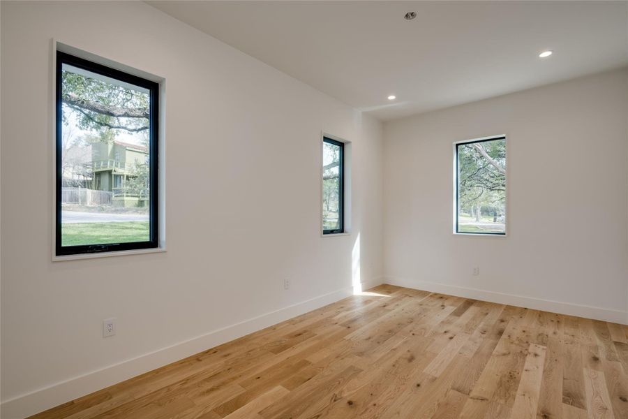 Unfurnished room with a wealth of natural light and light hardwood / wood-style flooring