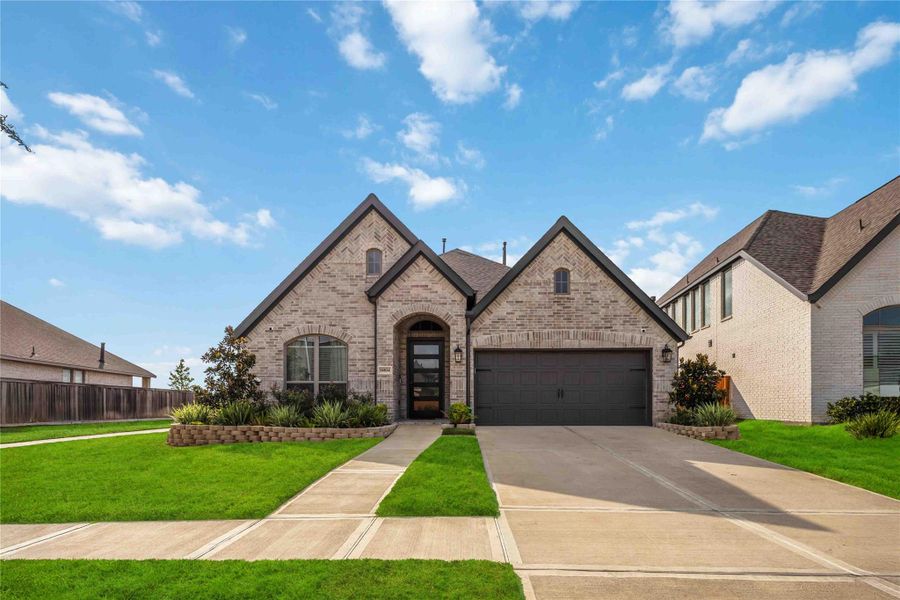 Front exterior of a new home in , Manvel, TX, highlighting curb appeal (Image 2). Front exterior of a new home in , Manvel, TX, highlighting curb appeal (Image 2).