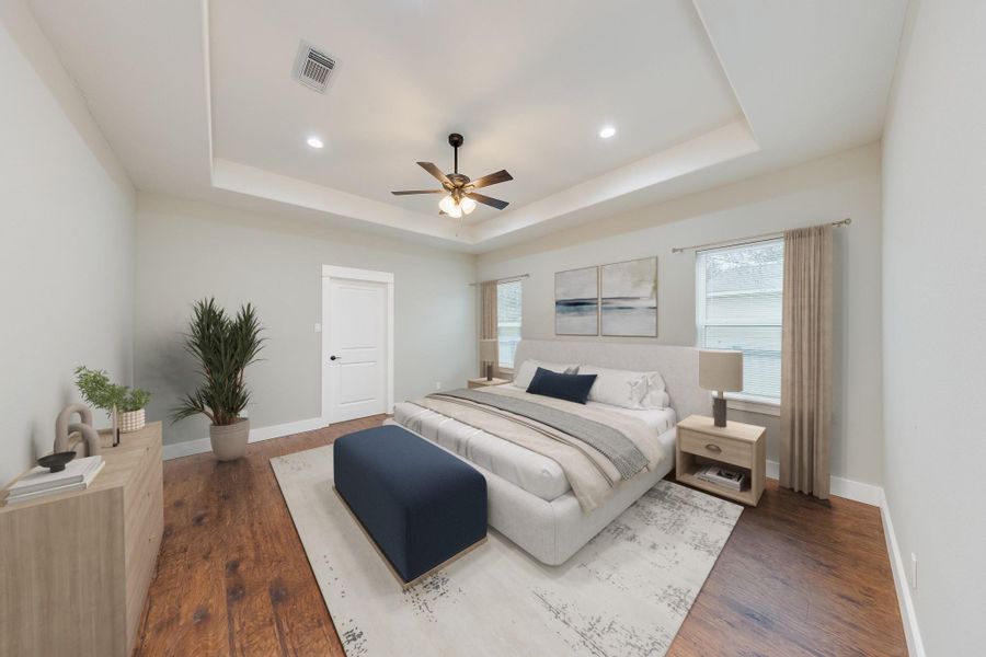Spacious primary bedroom with ample natural light, a walk-in closet, and a serene atmosphere for ultimate relaxation.