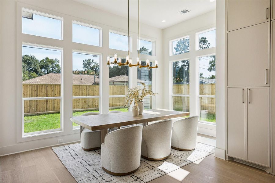 This elegant dining area is filled with soft natural light from surrounding windows, making it an easy favorite for quick breakfasts, relaxed weeknight dinners and long evenings gathered around the table with friends.