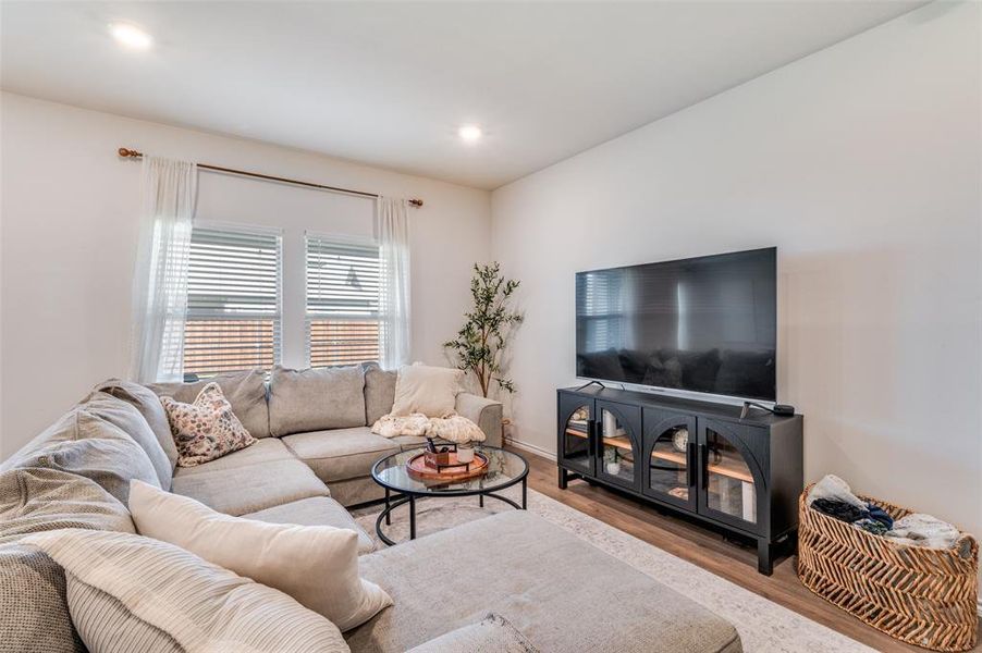 Living room with wood finished floors and recessed lighting