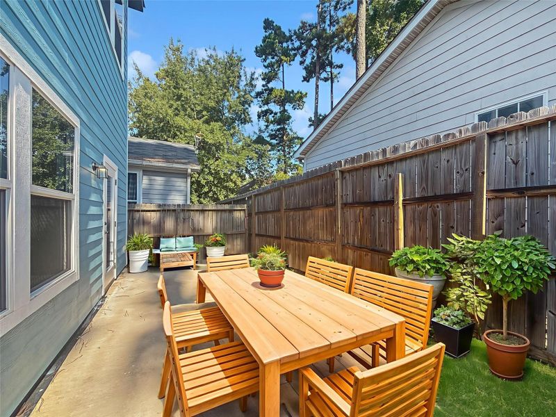 Expansive concrete patio leading to a spacious backyard. Virtually Staged.
