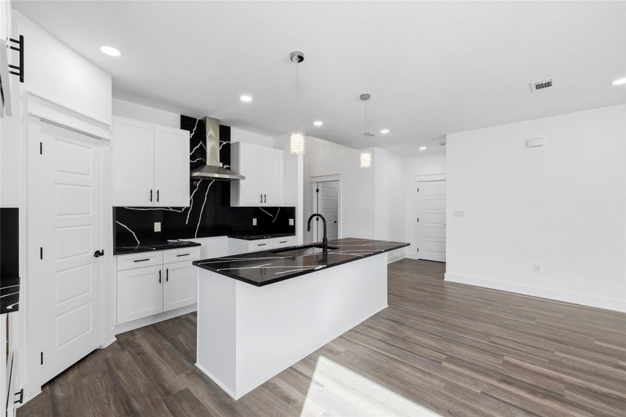 Kitchen island countertop is extended throughout the kitchen as a backsplash to match all.