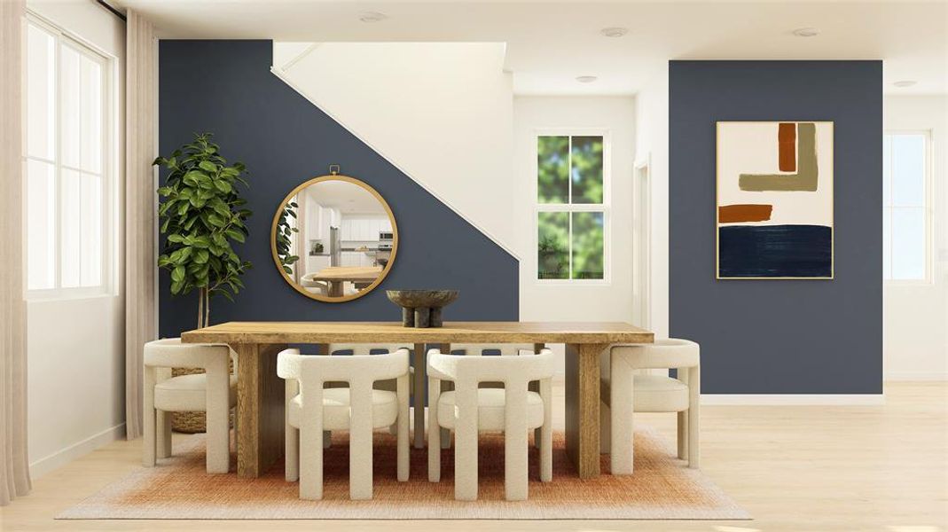 Dining area with light wood-style flooring and baseboards