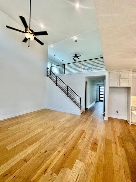 Tall ceilings and abundant natural light highlight this inviting open concept living area.
